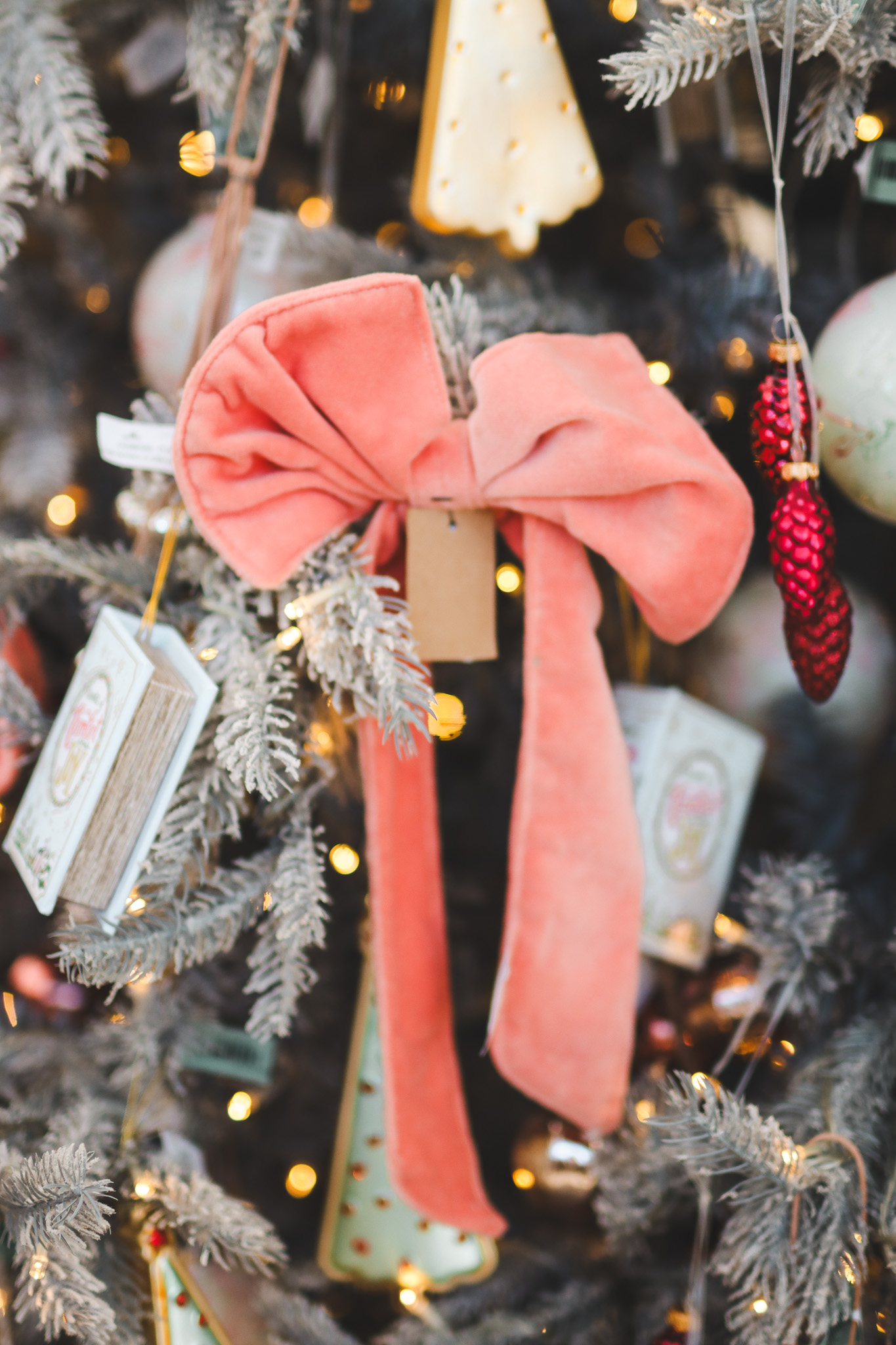 close-up of coral-colored bow on lifelike tree